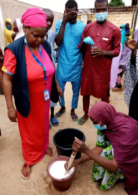 3. participants demonstrating mixing of chemicals for soap production-a